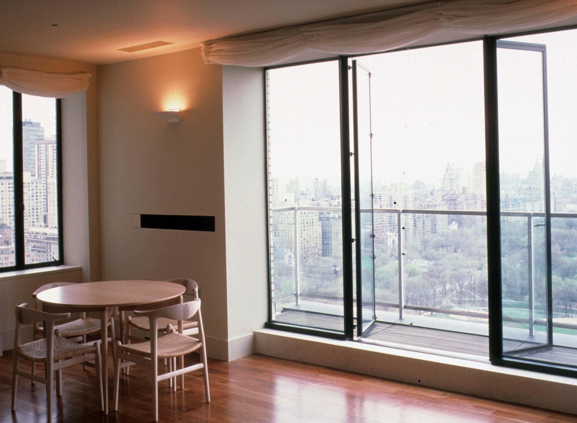 High-rise dining room with floor-to-ceiling windows framing Central Park